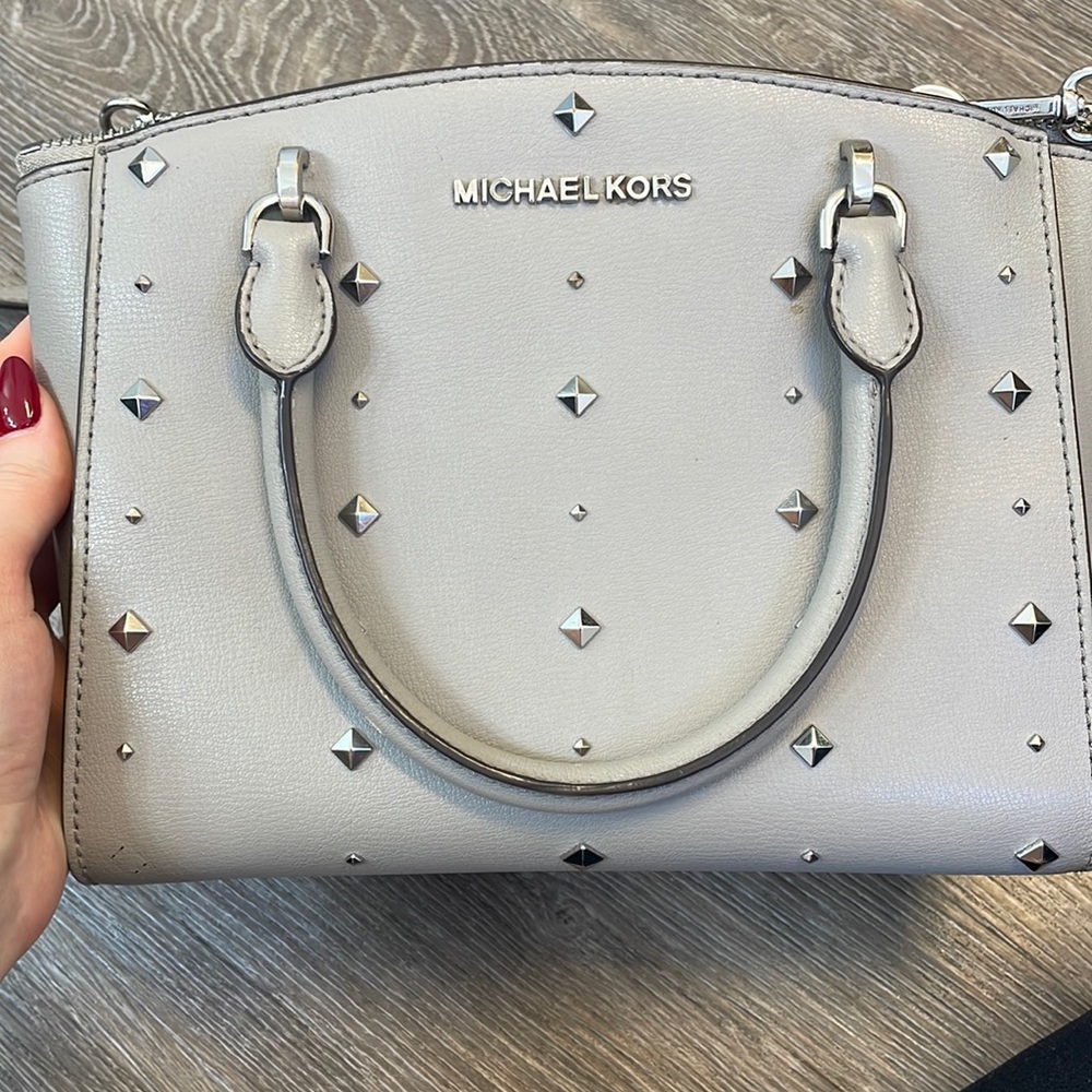 Medium sized Michael Kors crossbody purse with silver studded detail.